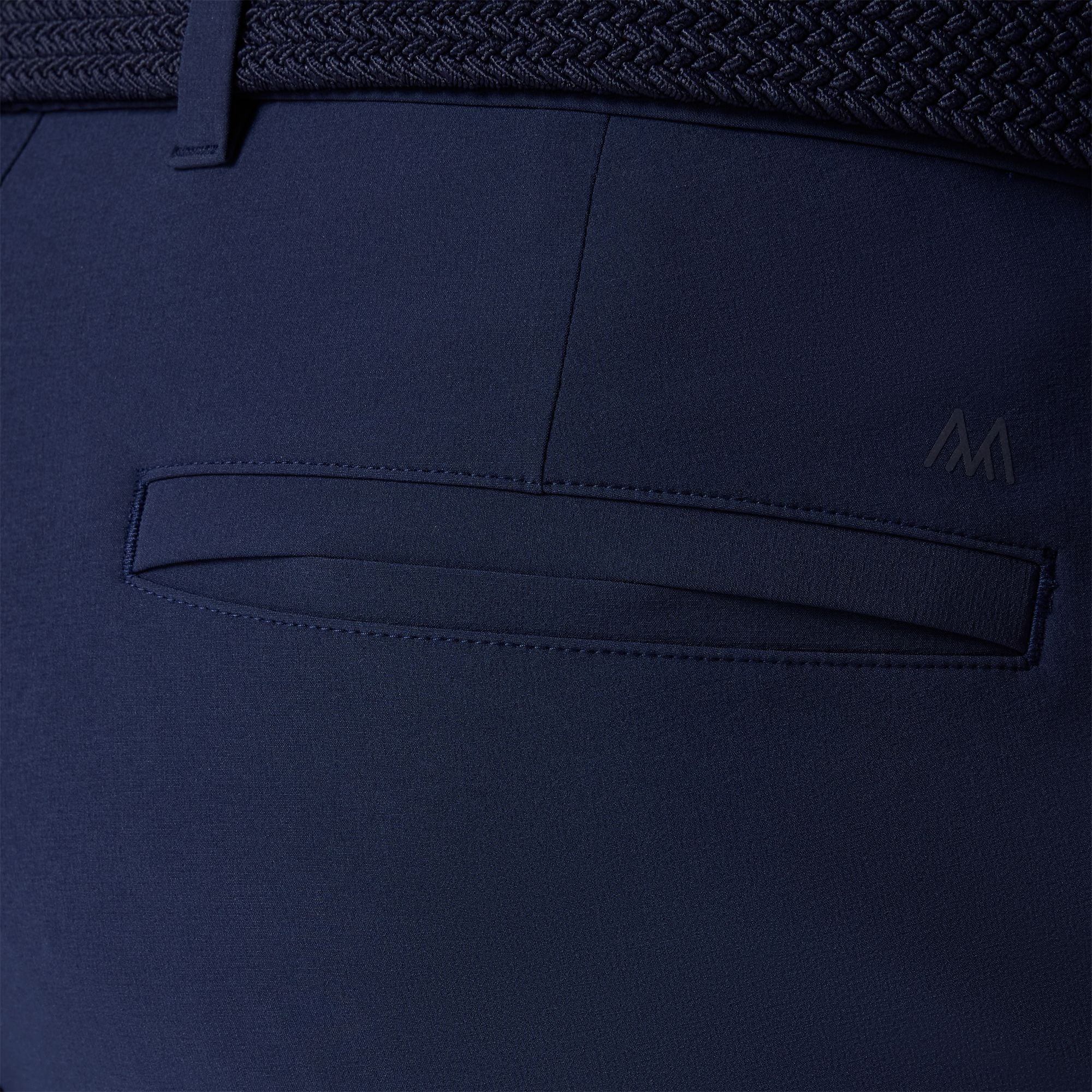 Close-up of a navy blue fabric with a pocket detail, showing texture and stitching.