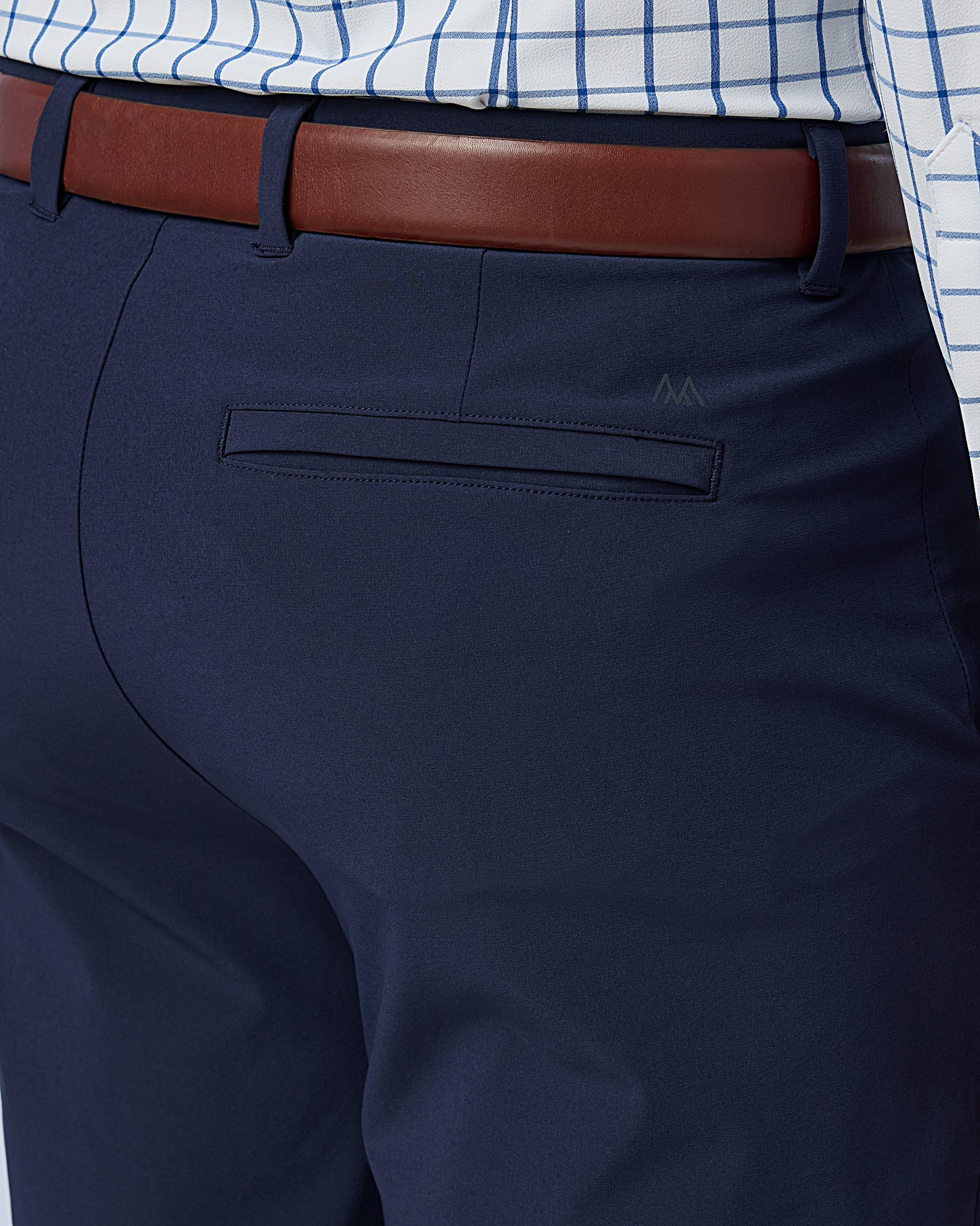 Navy pants with a brown belt and checkered shirt