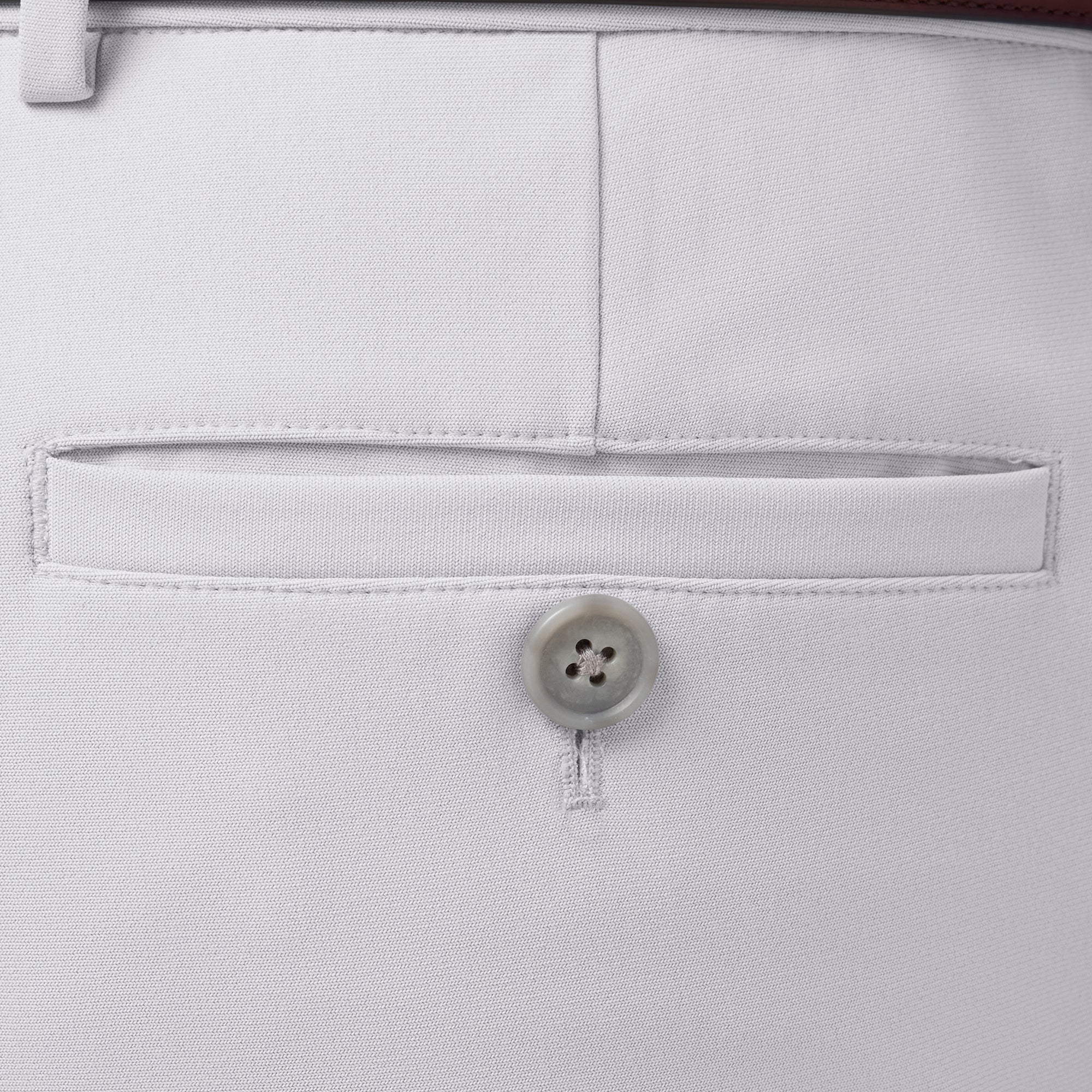 Close-up of a button on light gray pants