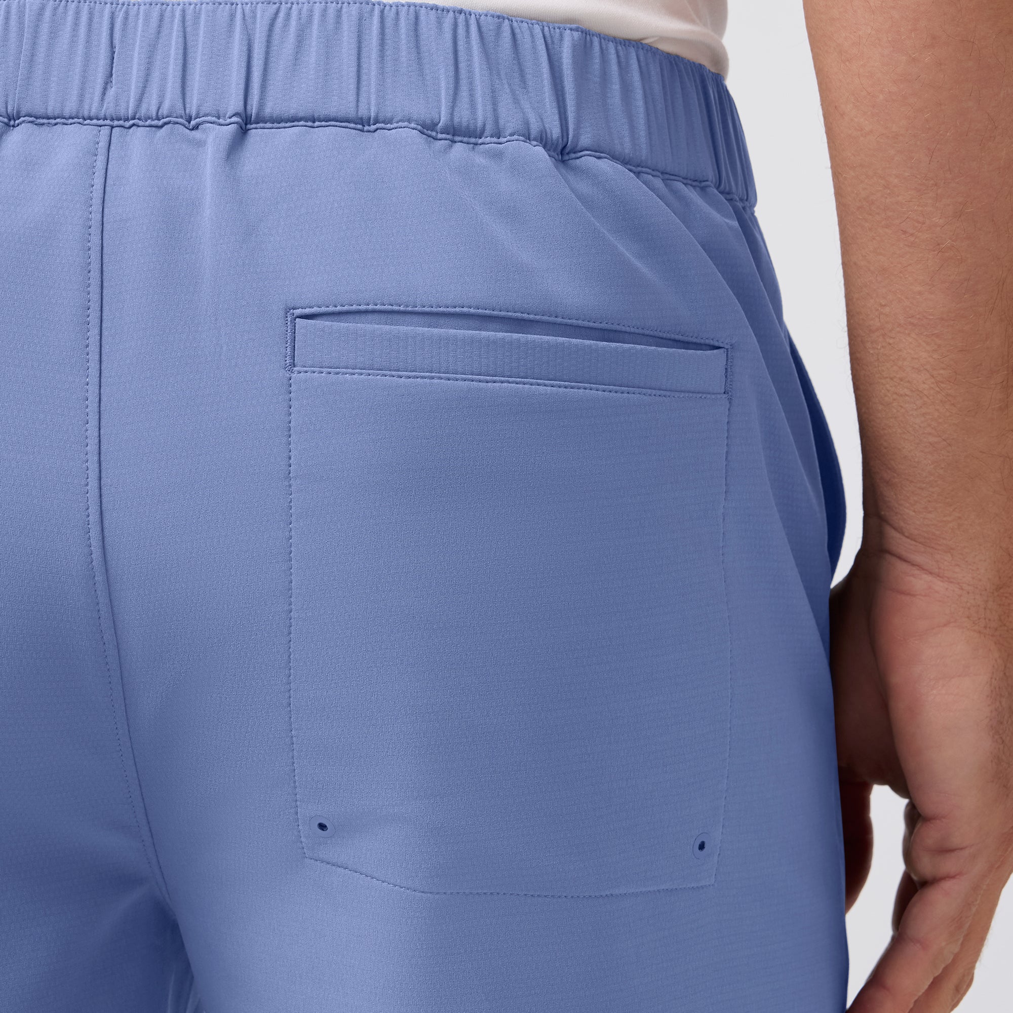 Close-up of blue pants with a pocket on a white background