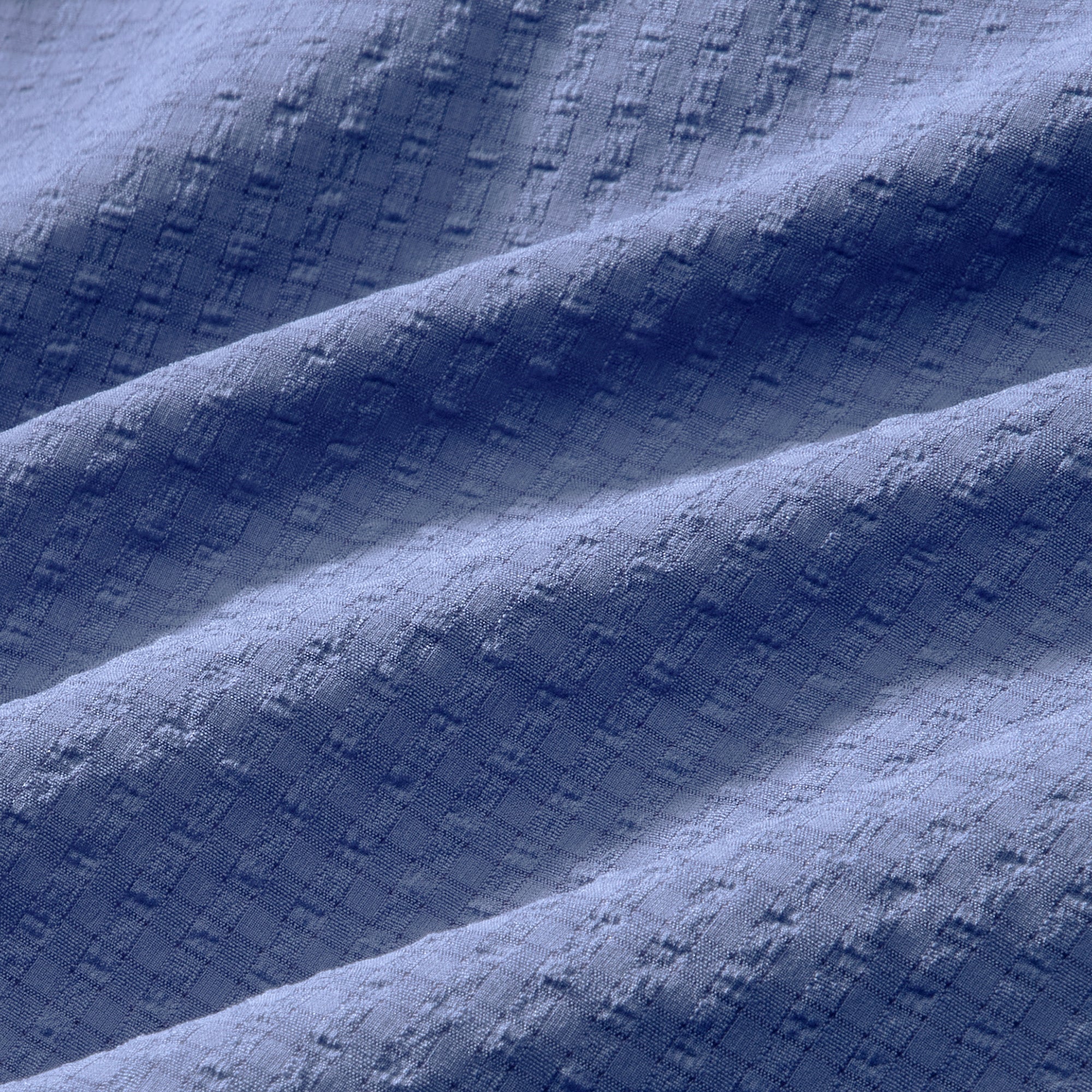 Textured blue fabric with folds