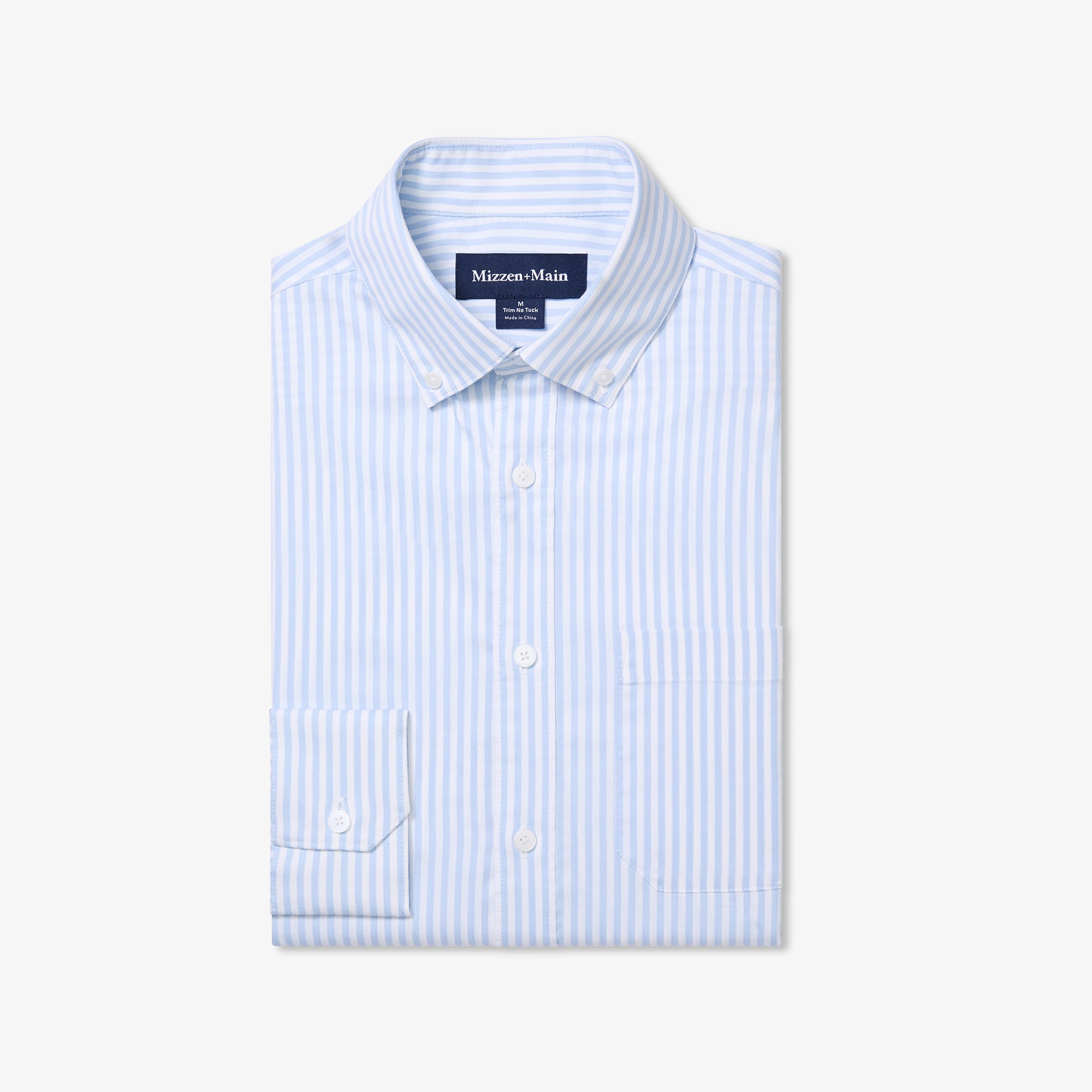 Folded light blue and white striped shirt with 'Mizzen+Main' label on a white background