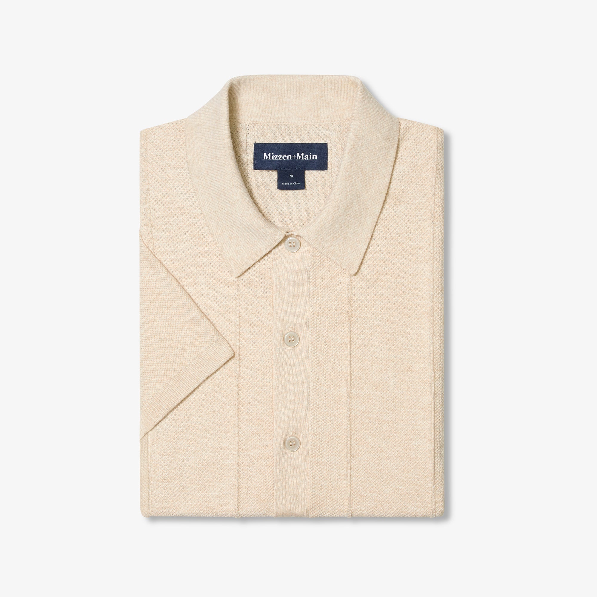 Beige short-sleeve shirt with collar on a white background, featuring Mizzen+Main label.