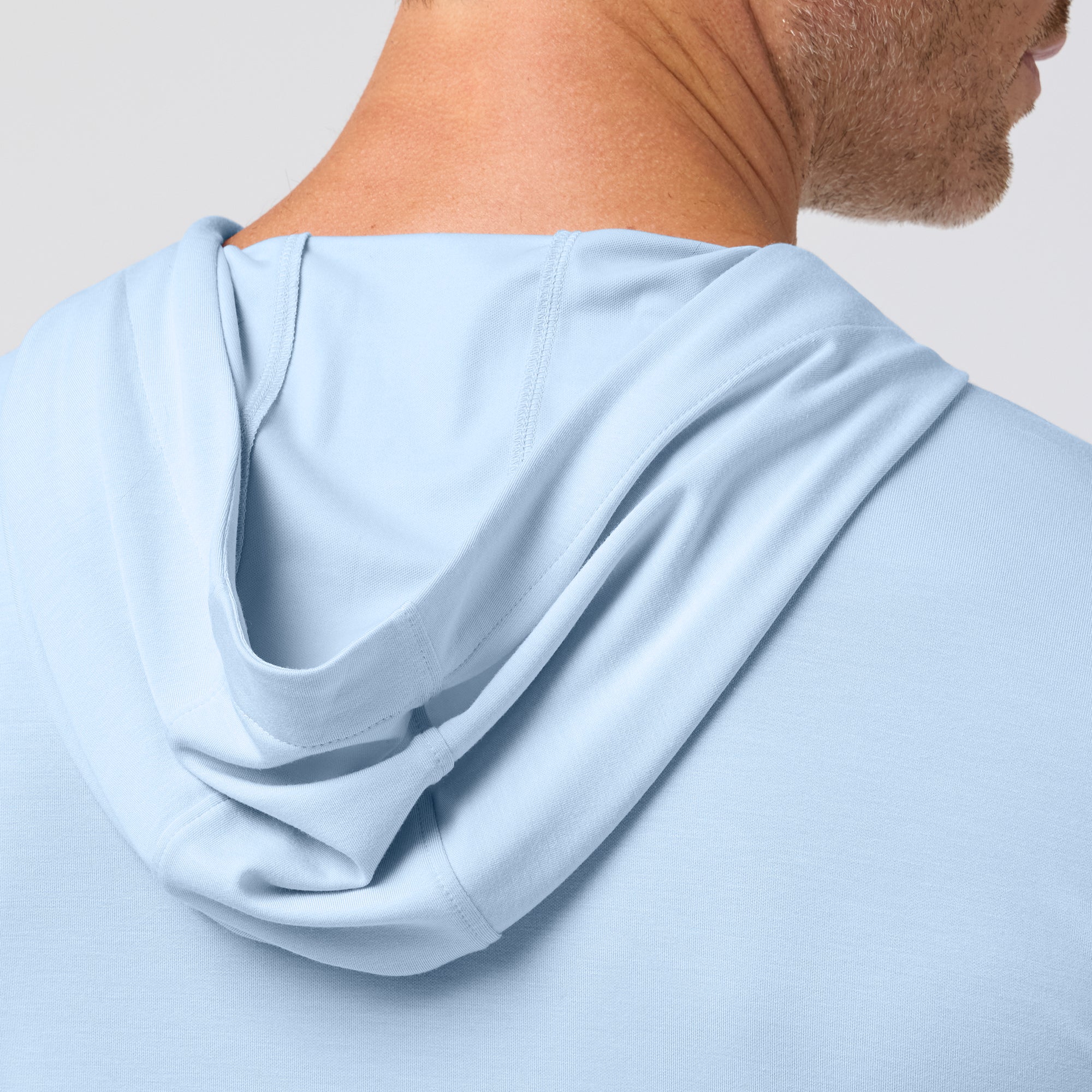 Light blue hoodie worn by a person on a plain background