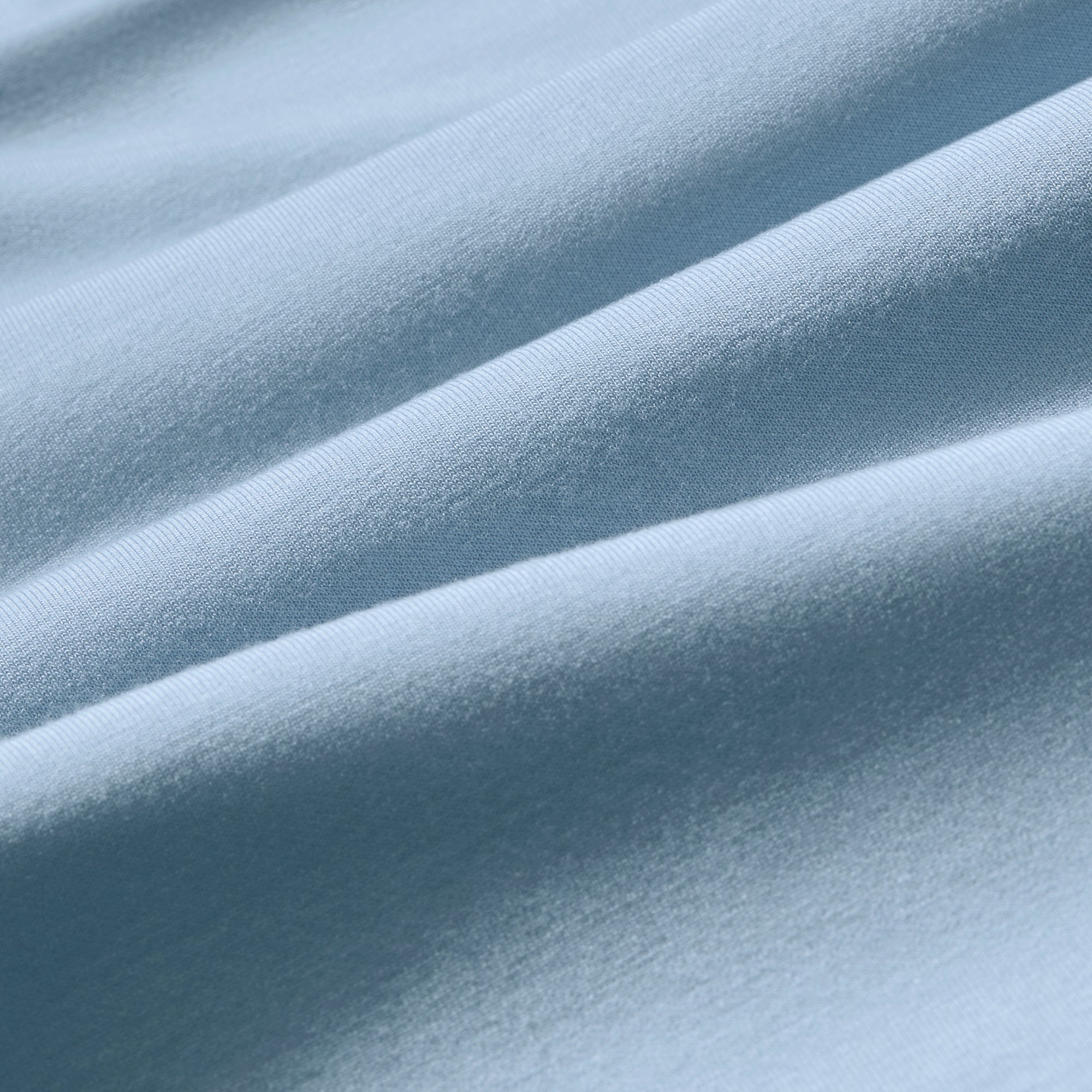 Close-up of light blue fabric with folds